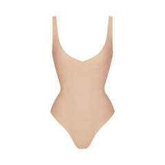 SKIMS BODY UNLINED PLUNGE THONG BODYSUIT | CLAY
